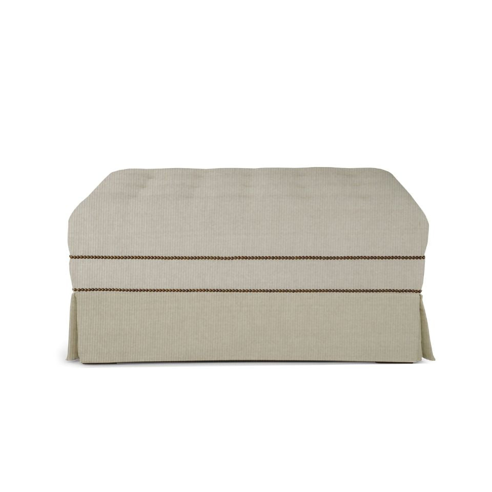 Vincent upholstered ottoman side view with skirt
